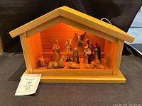 Full view of wood manger and illuminated Nativity figures
