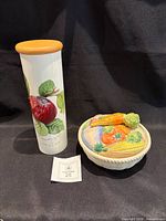 Portmeirion canister and Fitz & Floyd lidded dish side by side