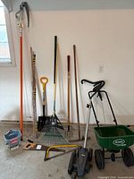 Group shot of all garden tools lined against wall