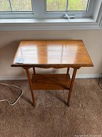 Full view of wood end table under window