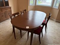 overall view of dining table with leaf installed and four chairs