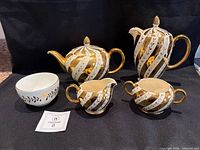 Front view of all five pieces displaying pattern and form