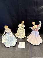 Front view of all three Royal Doulton figurines standing side by side