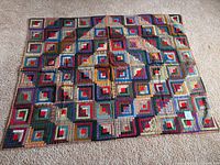 Full view of twin patchwork quilt laid flat