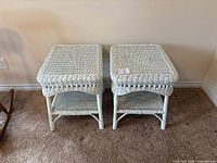 Front view of two matching white rattan wicker end tables