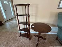Round pedestal table and five-tier corner shelf together for scale and finish.