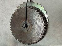 front view of stacked vintage circular saw blades, showing rust and wear