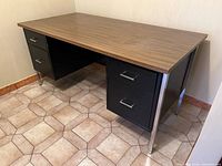 Full view of desk angled, showing top, drawers, legs