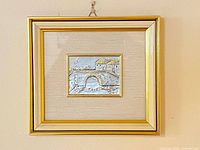Front view of framed plaque hanging on wall