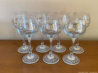 Front view of all seven Olympic wine glasses