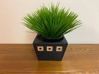 Faux grass in ceramic planter front view