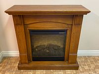 Front view of oak electric fireplace console