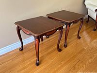 Both matching accent tables side by side on hardwood floor