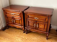 Front view of both nightstands showing drawer, cabinet doors, hardware, and legs
