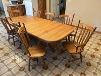 Table fully extended with eight chairs surrounding