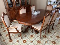 Dining table with six chairs placed around it