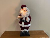 Front view of animated Santa showing suit, candle lit, base
