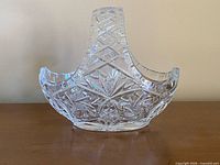 Front view of lead crystal basket bowl showing handle and deep-cut patterns