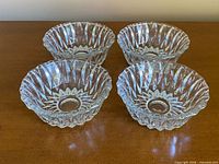 Top view of four matching pressed glass bowls