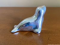 Left side view of polished aluminum seal figurine