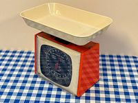 Front view showing orange body, cream tray, black dial