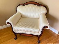 Front view of upholstered Queen Anne arm chair