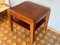 Full view of wood side table showing starburst top and shelf