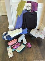 All clothing items, sneakers, scarves, pouches, accessories laid out for overview