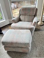Recliner armchair and ottoman showing full upholstery pattern and overall condition