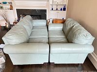 Front view of both leather sofa and loveseat side by side