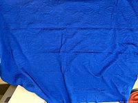 Entire bedspread laid out showing overall size and royal blue color