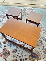 Top view of coffee table and two end tables showing teak veneer and overall style