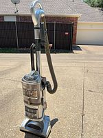 Front view of Shark Lift-Away Deluxe upright vacuum showing dust cup and branding