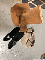 Three pairs of boots: chestnut tall, black ankle, taupe ankle