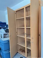 Wardrobe open showing interior divider and six fixed shelves, stain visible on bottom shelf