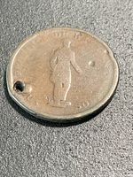 Obverse of coin showing habitant figure and hole