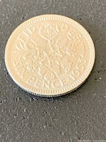 Reverse of 1953 sixpence coin showing floral design and date