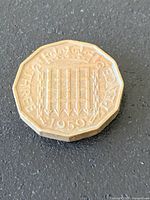 Reverse side showing Tudor portcullis, date, denomination