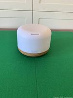 Front view of diffuser showing wood-grain base and white top