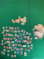 Overview of scattered stamp assortment on felt surface