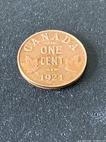 Reverse of 1921 Canadian one-cent coin showing denomination, maple leaves and date
