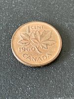 Reverse of 1960 Canada 1-cent coin showing date, denomination and maple leaves