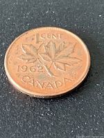 Reverse side of 1962 Canadian one-cent coin showing maple leaf design and date