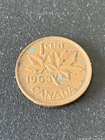 Reverse side of 1963 Canada one-cent coin showing maple leaves and date