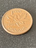 Reverse of 1964 Canadian penny showing maple leaf design and date