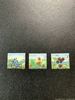three stamps side by side showing designs and condition