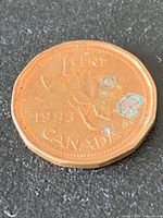 Reverse side showing date 1993, denomination 1 CENT, maple leaves, corrosion spots
