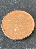 Close-up of reverse side displaying date, denomination and leaf design