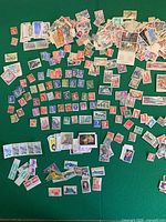 Overview of entire spread of French stamps on green surface