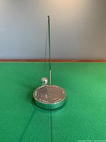 Front view of decision maker showing pendulum and base